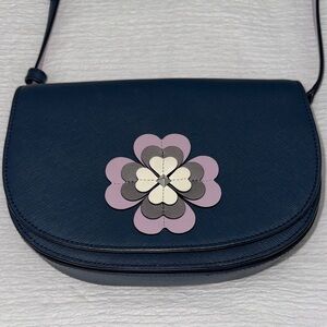 kate spade navy crossbody with purple and cream floral appliqué